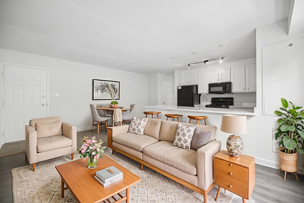 A living room with a couch, chairs, and a coffee table.