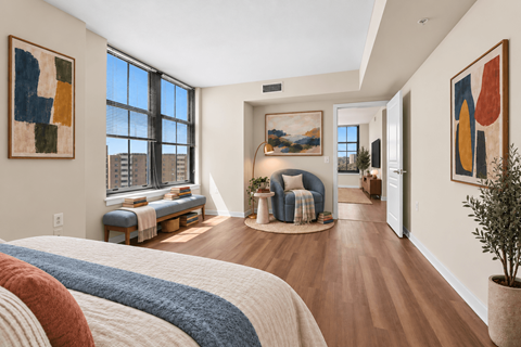 A bedroom with a large bed and a view of the city.