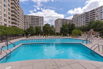 Olympic-Sized Pool with Swimming Lanes, Free Swim Area, and Expansive Sundeck with Chaise Lounge Chairs Spacious Apartment Rentals in Crystal City Arlington VA - Photo Gallery 4