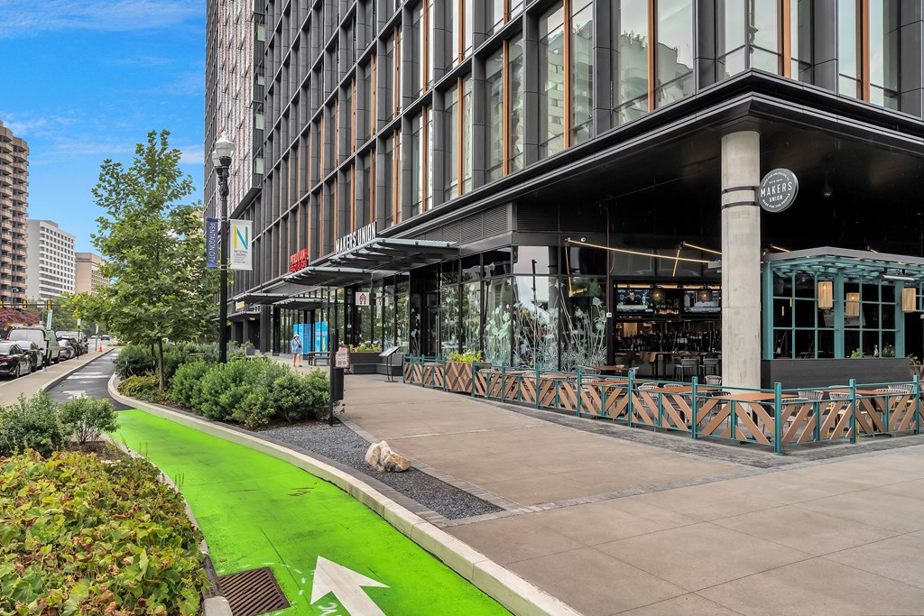 a sidewalk in front of a building with a dog