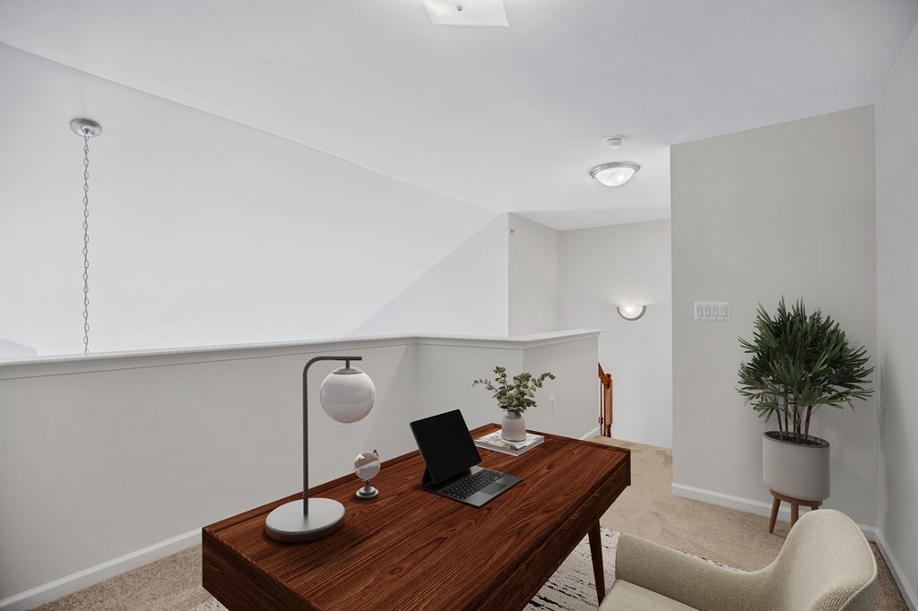 A modern home office with a laptop on a desk.