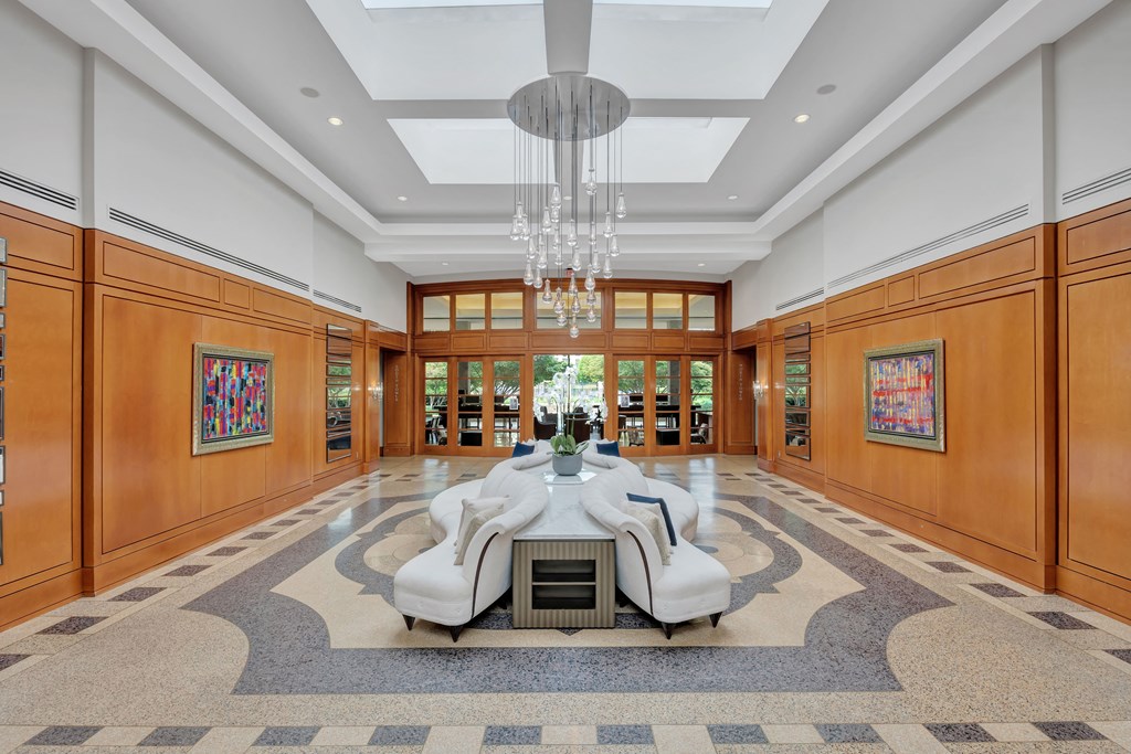 a dining room with a large table and chairs in the middle of a large room