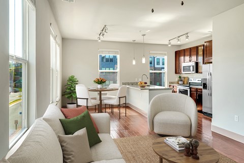 A modern living room with a white couch and a coffee table.