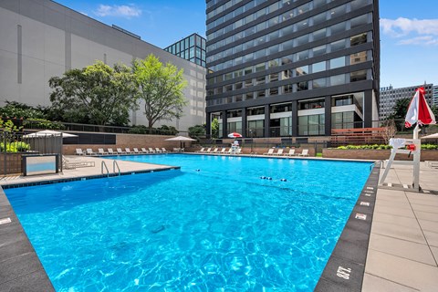 A large blue swimming pool in front of a building.