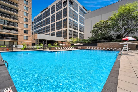 A large swimming pool in front of a building.