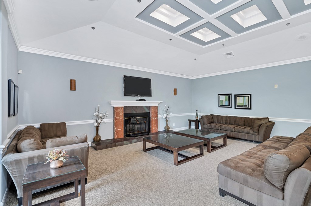 a living room with blue walls and a coffered ceiling with skylights