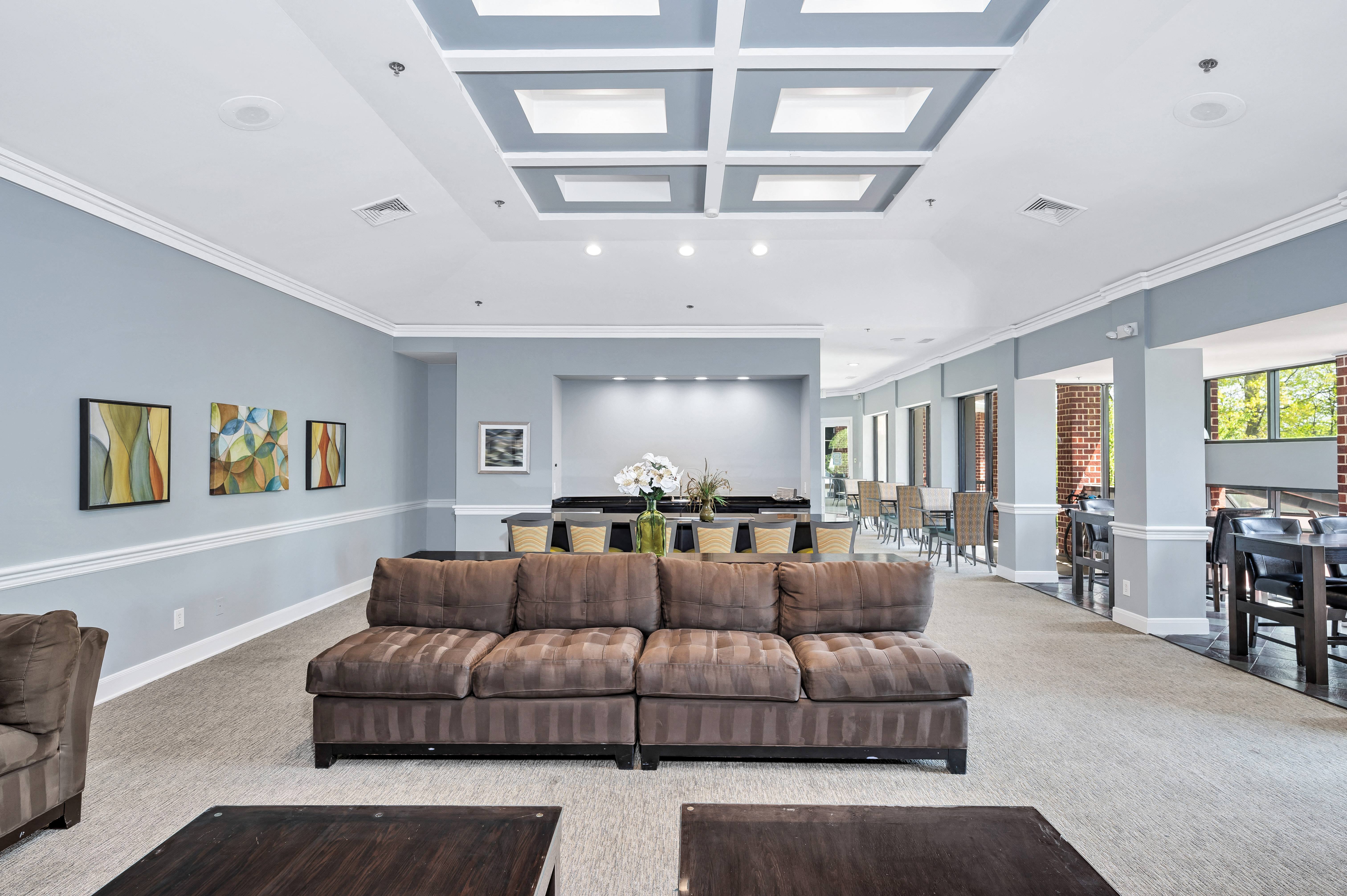 a large living room with a couch and a table