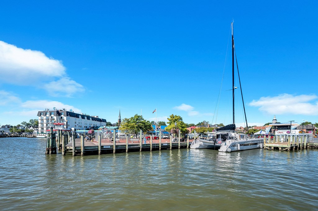 a group of boats docked at a dock on the water
