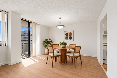 A dining room with a table and chairs.
