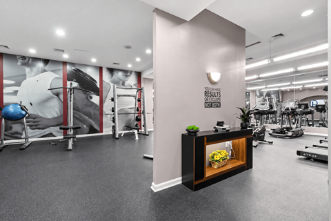 A gym with a variety of equipment and a sign that reads