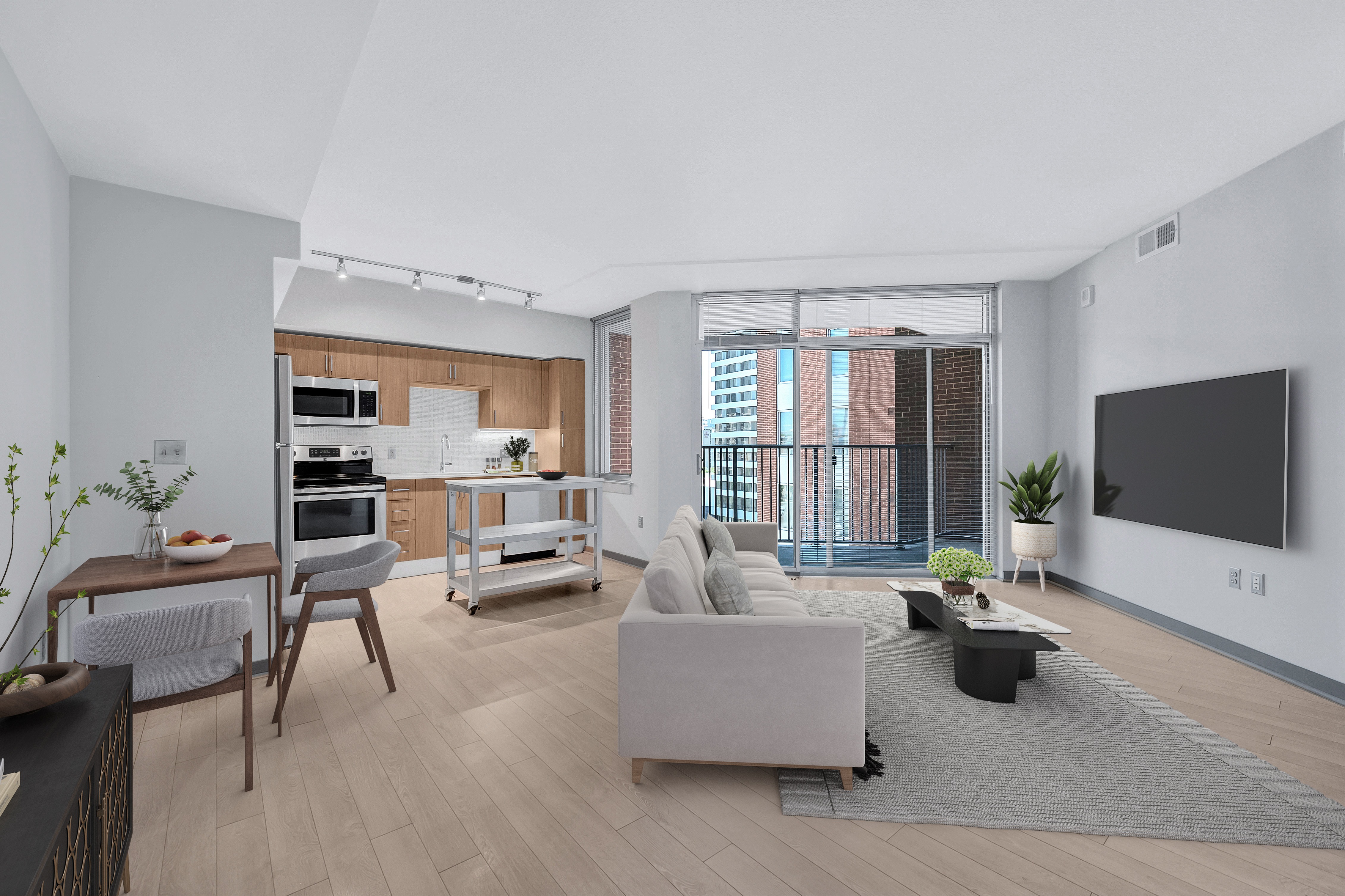 A modern living room with a grey sofa and a television on the wall.