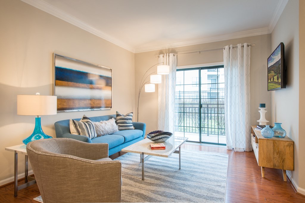 Spacious living areas with hardwood flooring at The Cosmopolitan at Lorton Station, Lorton