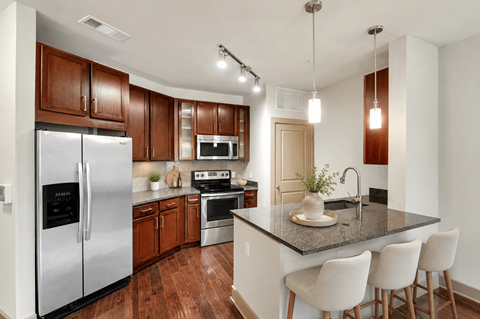 A kitchen with a refrigerator, stove, and oven.