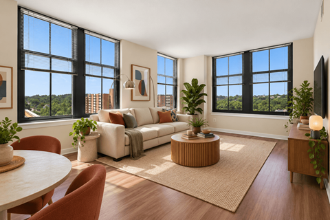 A living room with a white couch and a large window.