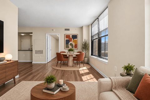 A living room with a brown coffee table and a grey couch.