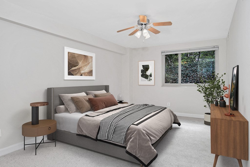 a bedroom with a bed and a ceiling fan