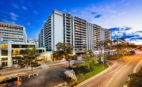 A modern building with a parking lot in front of it.