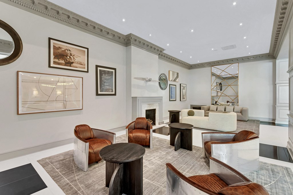 a living room with couches and chairs and a fireplace