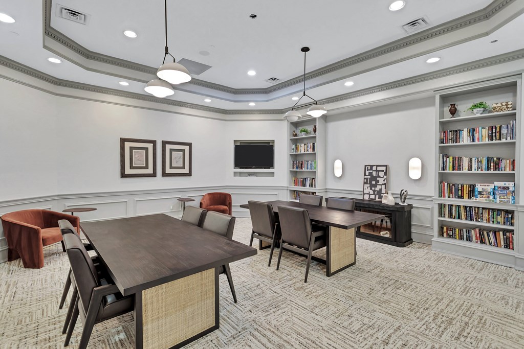 a conference room with a table and chairs and a library