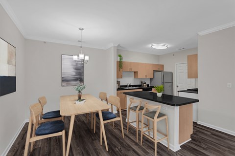 A kitchen with a table and chairs.