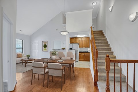A dining room with a wooden table and chairs.