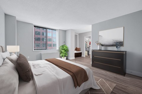 A bedroom with a large bed and a dresser.