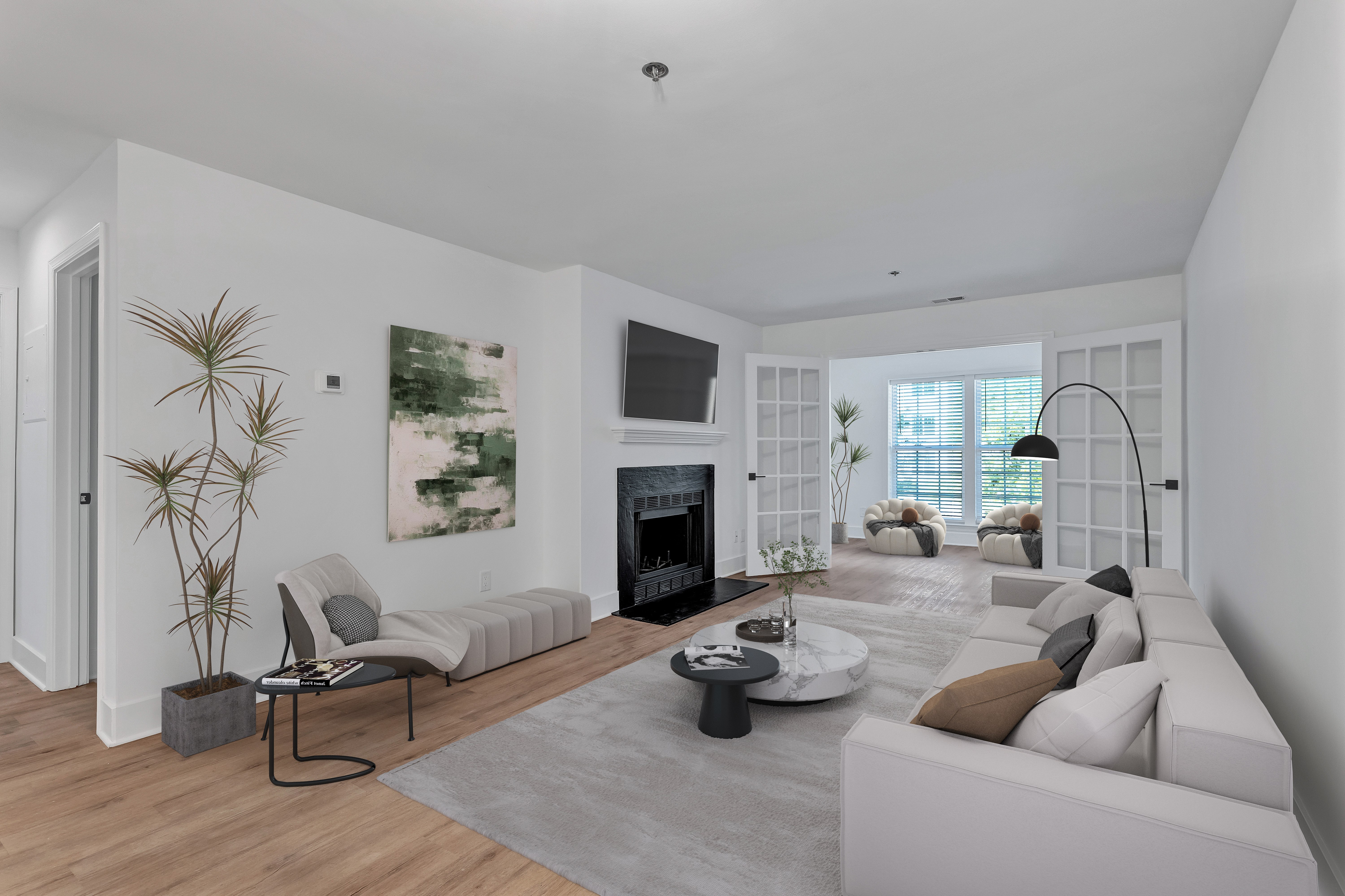 A modern living room with a fireplace and a large painting on the wall.