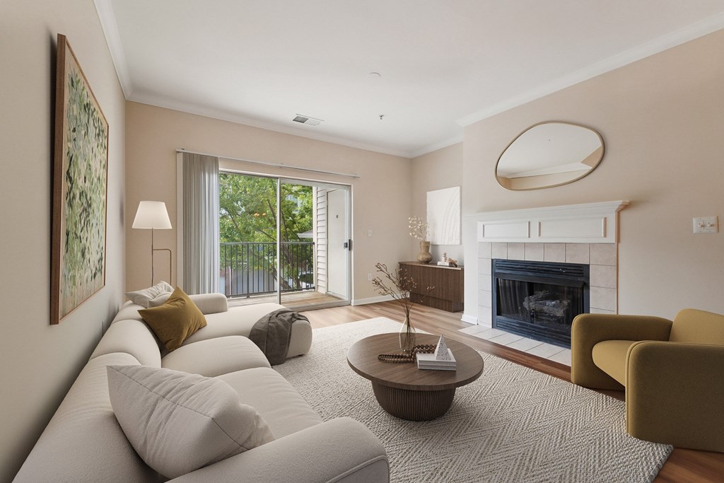 A living room with a fireplace and a painting on the wall.