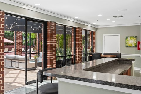 A kitchen with a black counter top and a white door.