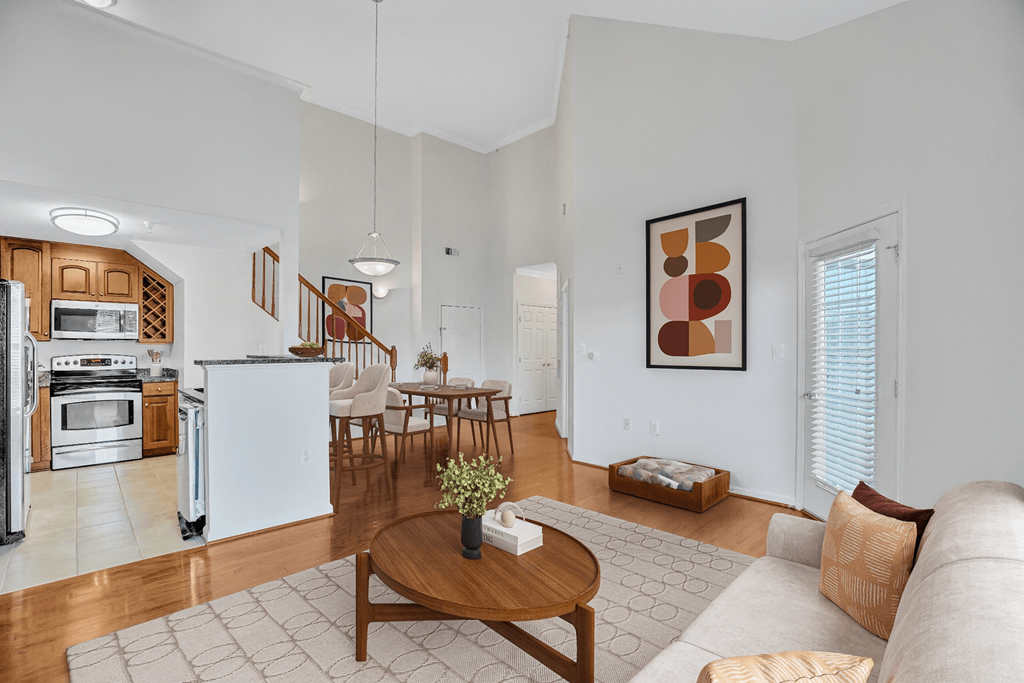 A modern kitchen with a dining table and chairs.