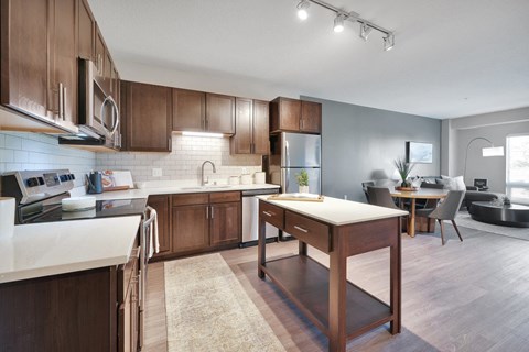 A modern kitchen with wooden cabinets and a central island.