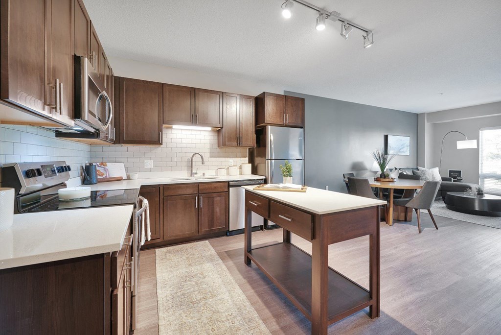 A modern kitchen with wooden cabinets and a central island.