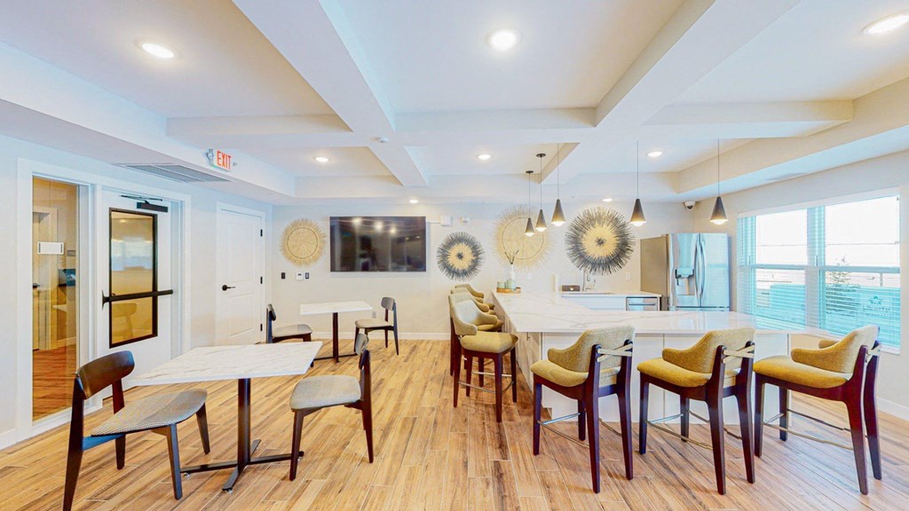 A dining room with a white table and chairs.