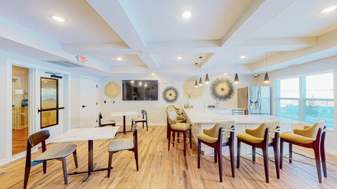 A dining room with a white table and chairs.