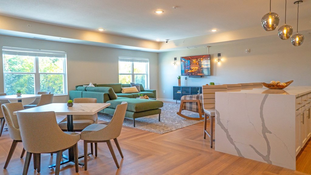 A modern living room with a dining table and chairs.