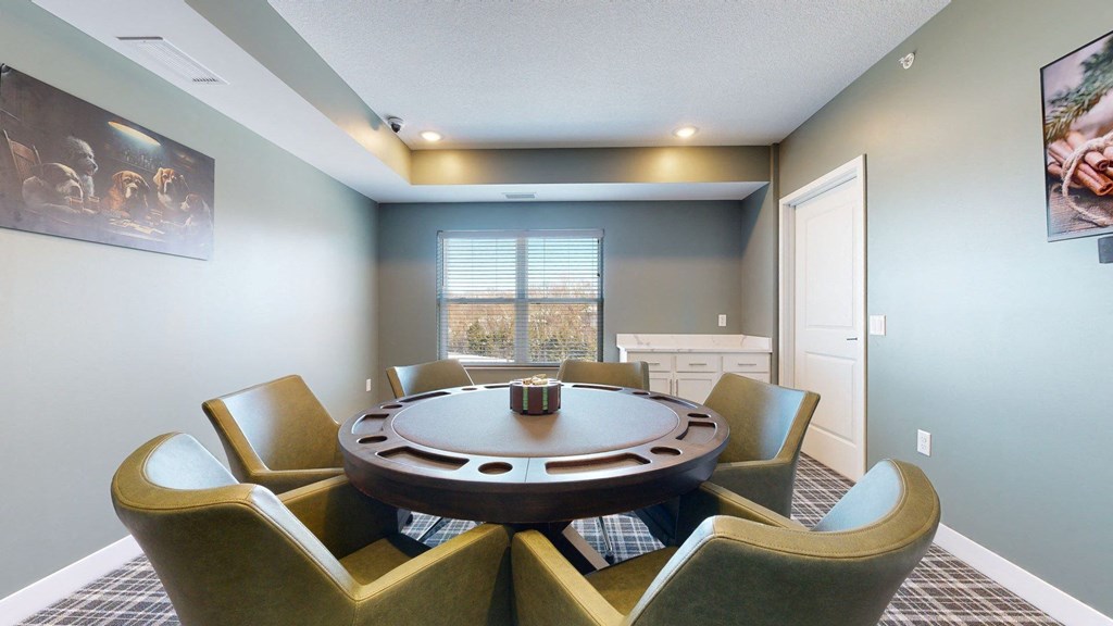 A round table with six chairs around it in a room.