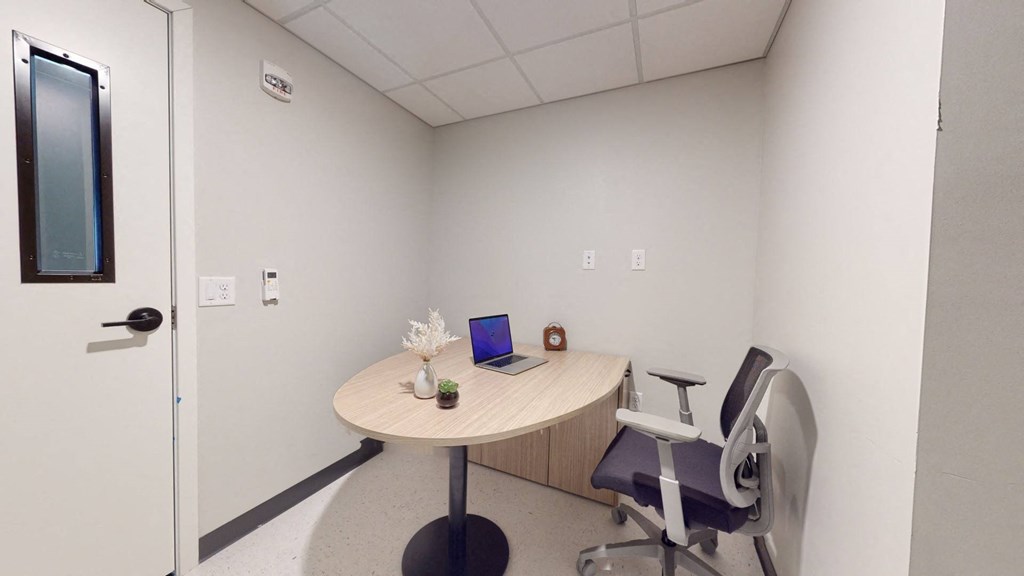 A small room with a round table and a chair.
