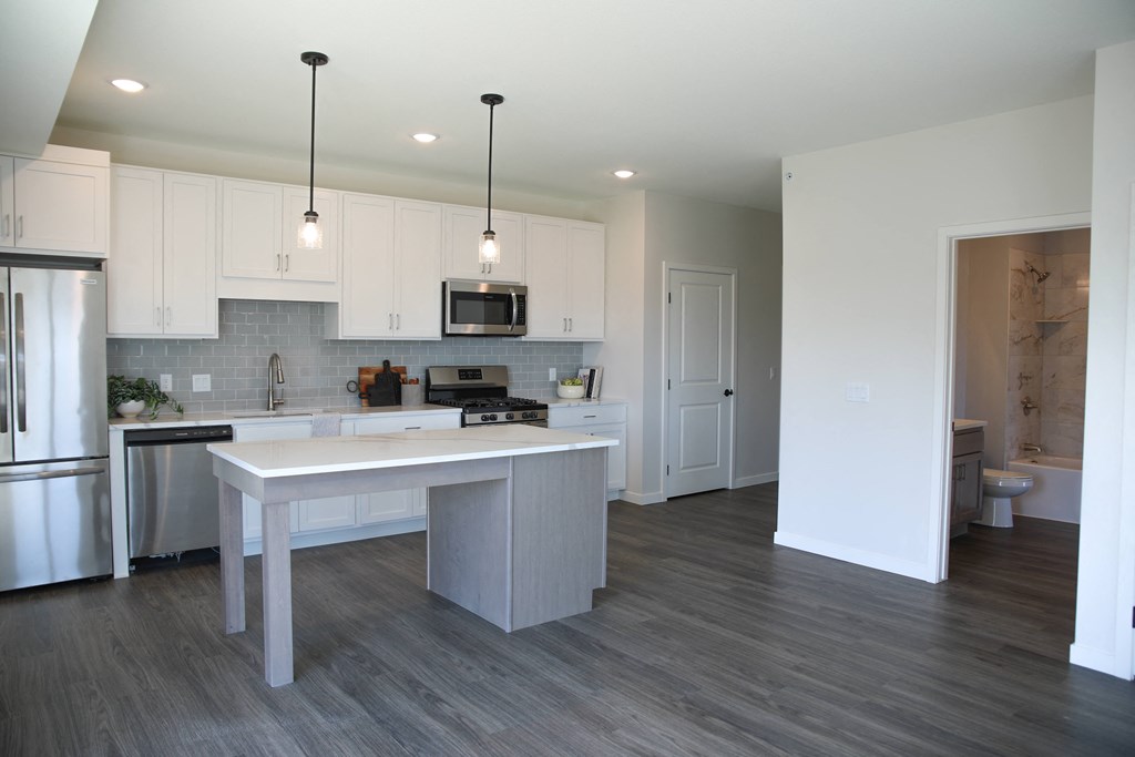 a kitchen and dining area in a 555 waverly unit