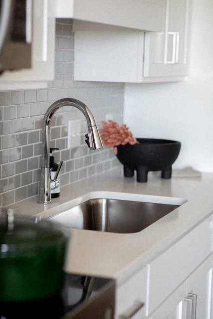 a kitchen with a sink and a faucet