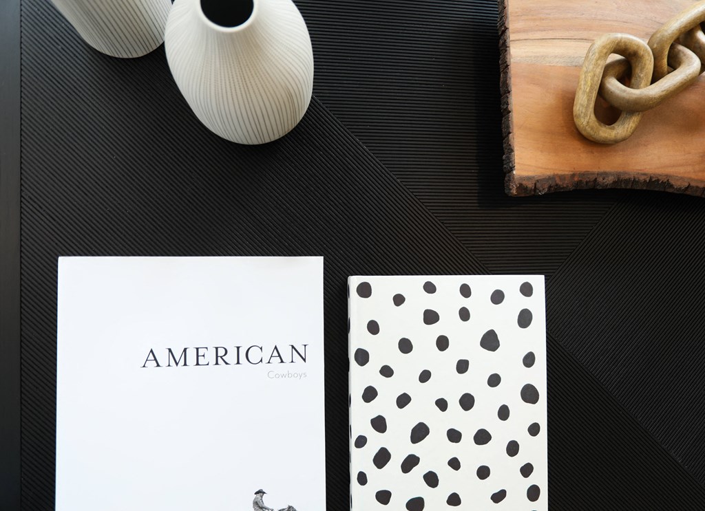 a picture of a white card with black dots on it on a table next to a wooden