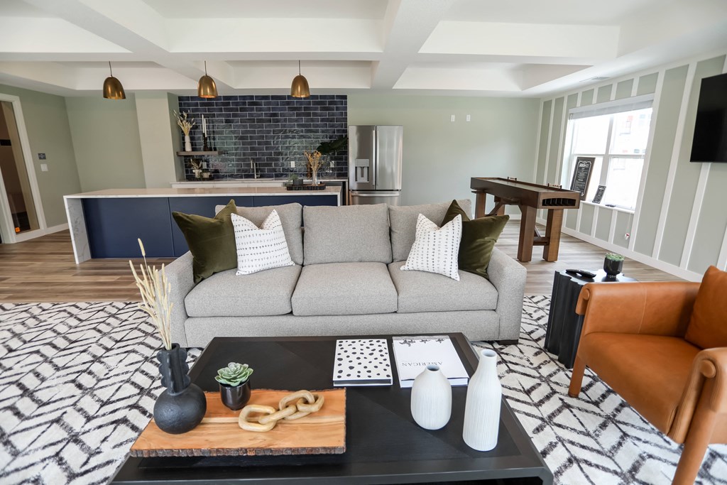 a living room filled with furniture and a large window