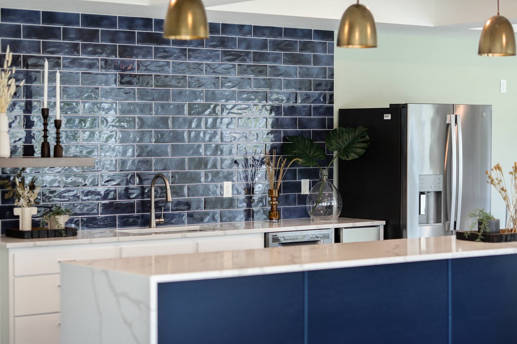 a kitchen with navy blue cabinets and white countertops