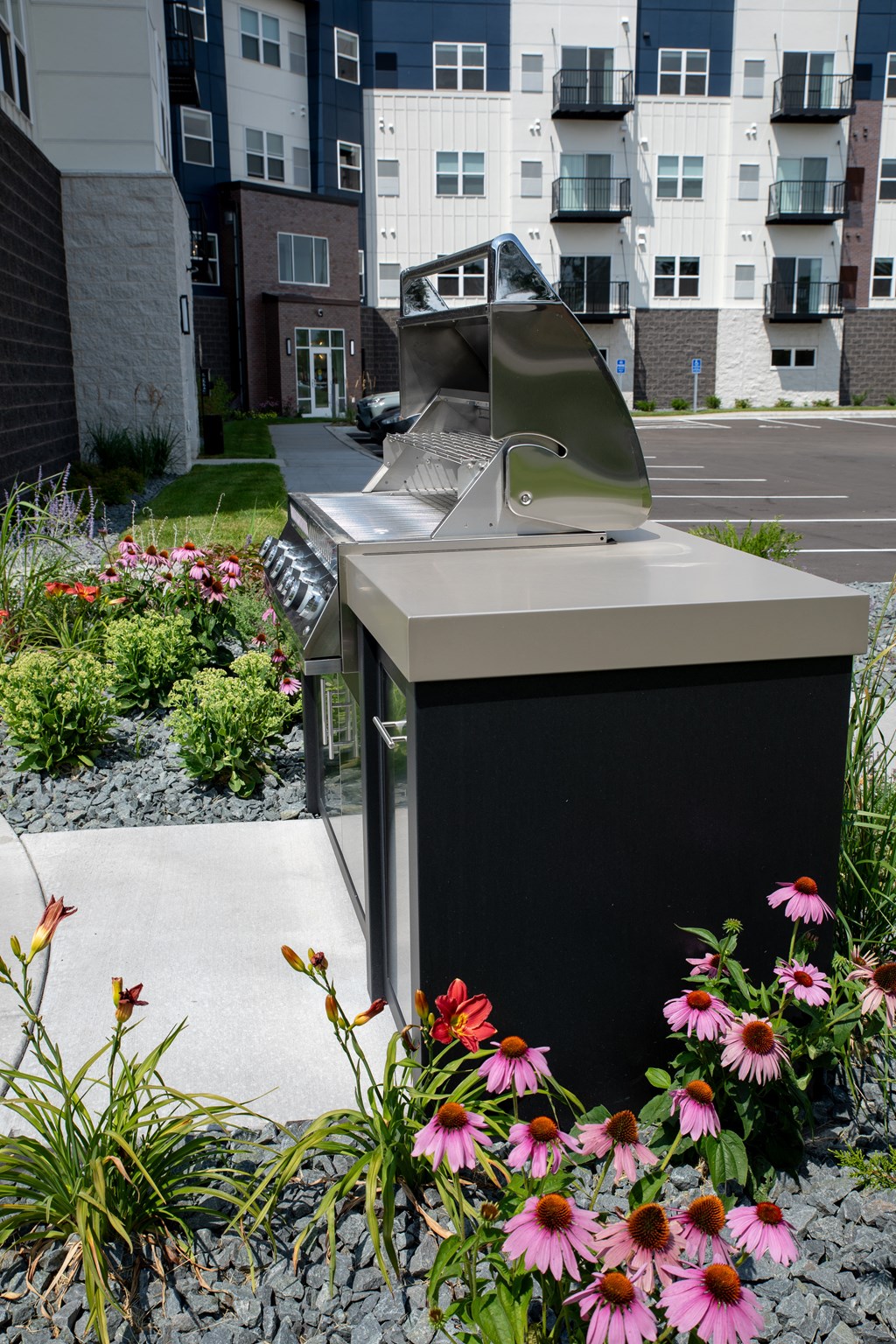 an outdoor bbq with flowers in the foreground