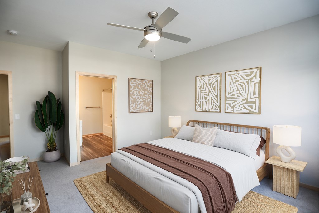 a bedroom with a large bed and a ceiling fan