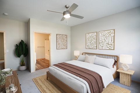 a bedroom with a large bed and a ceiling fan