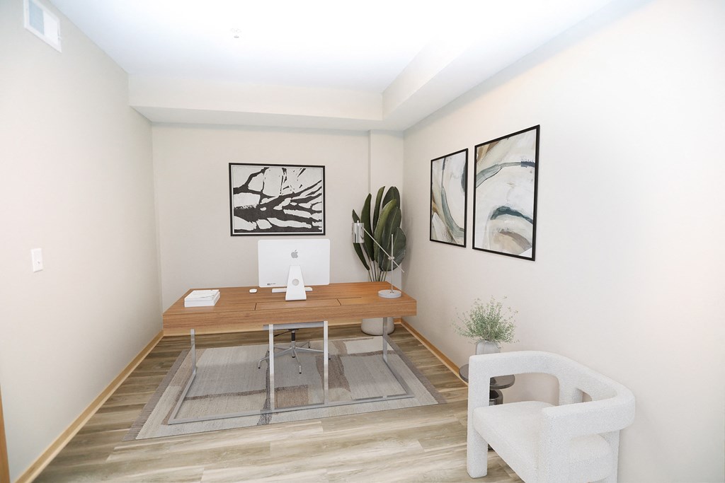 a small room with a wooden desk and a chair