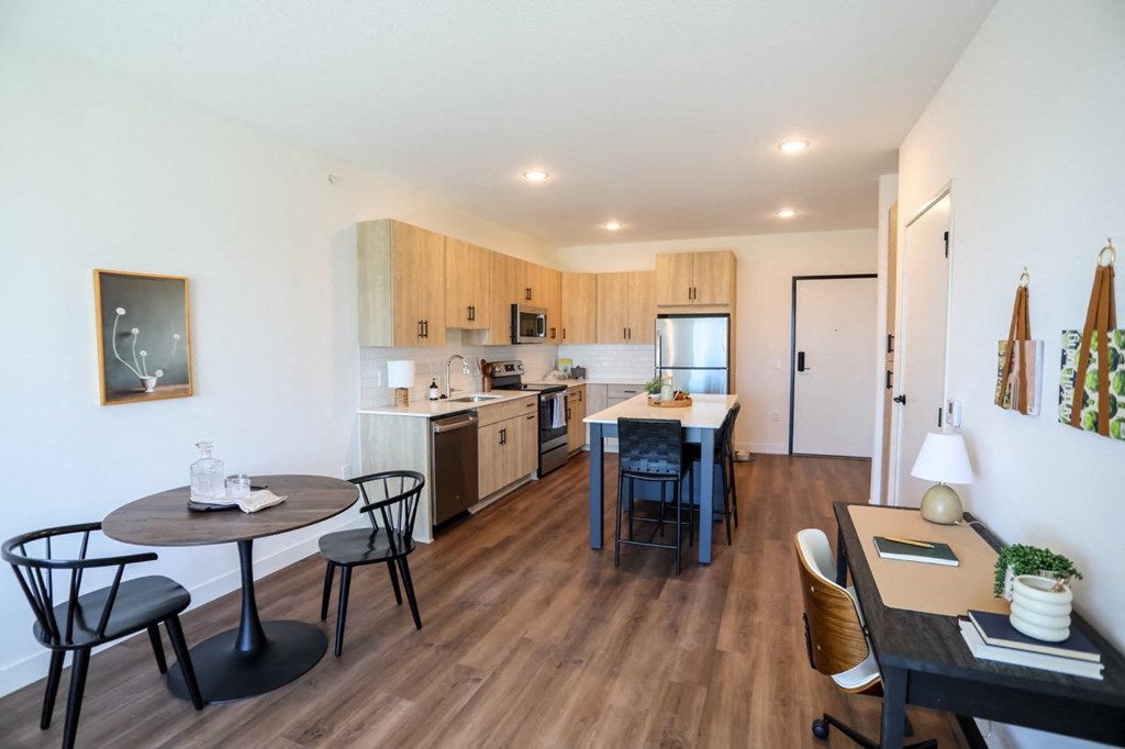 a kitchen and dining area with a table and chairs