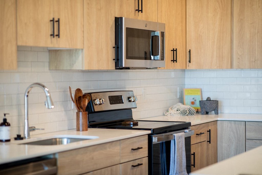 a kitchen with a sink and a stove and a microwave
