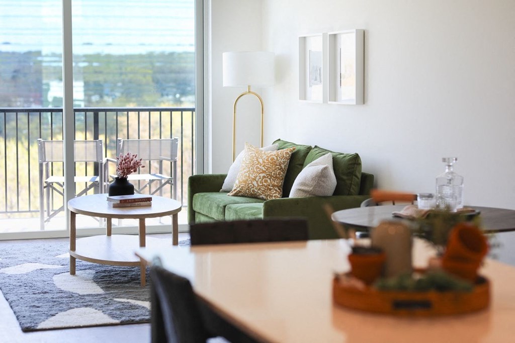 a living room with a green couch and a table
