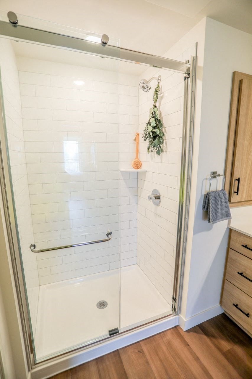 a small bathroom with a shower with a glass door